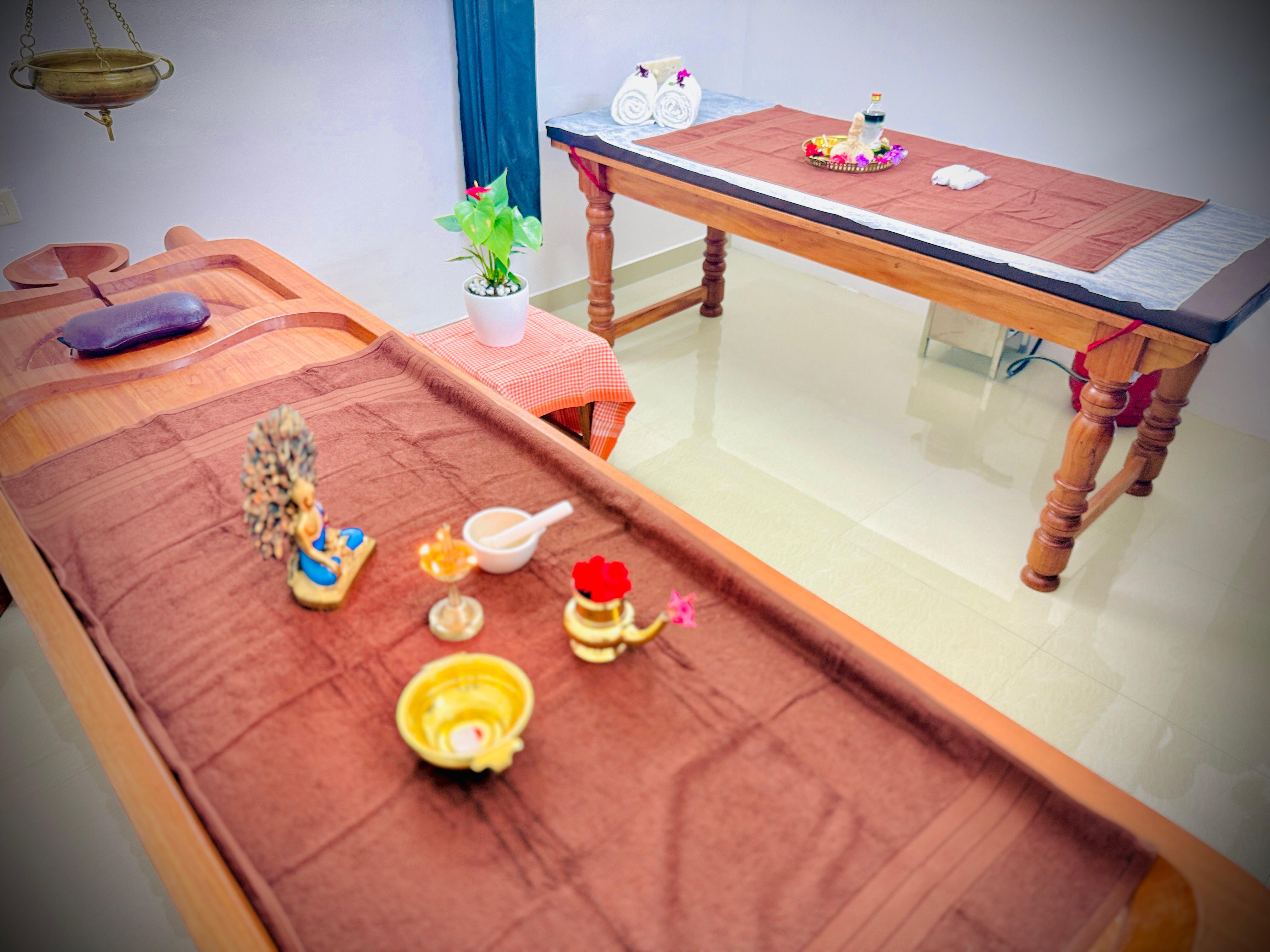 Therapist applying warm herbal oil during an Ayurvedic full-body massage