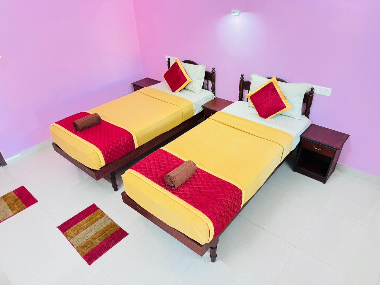 Twin bed room with yellow and red bedding