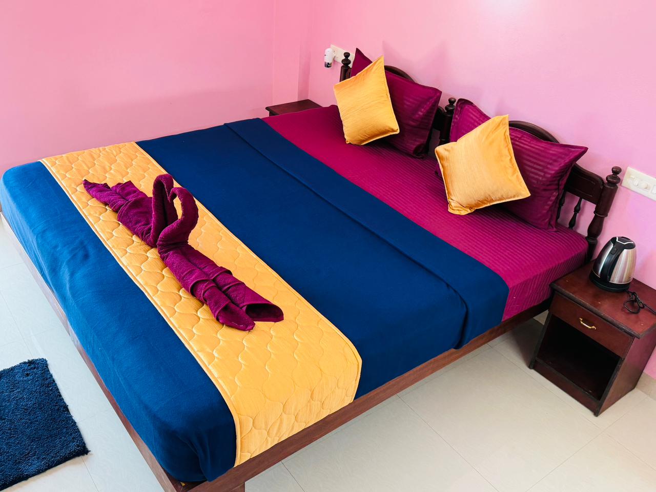 Close view of double bed with folded towel arrangement