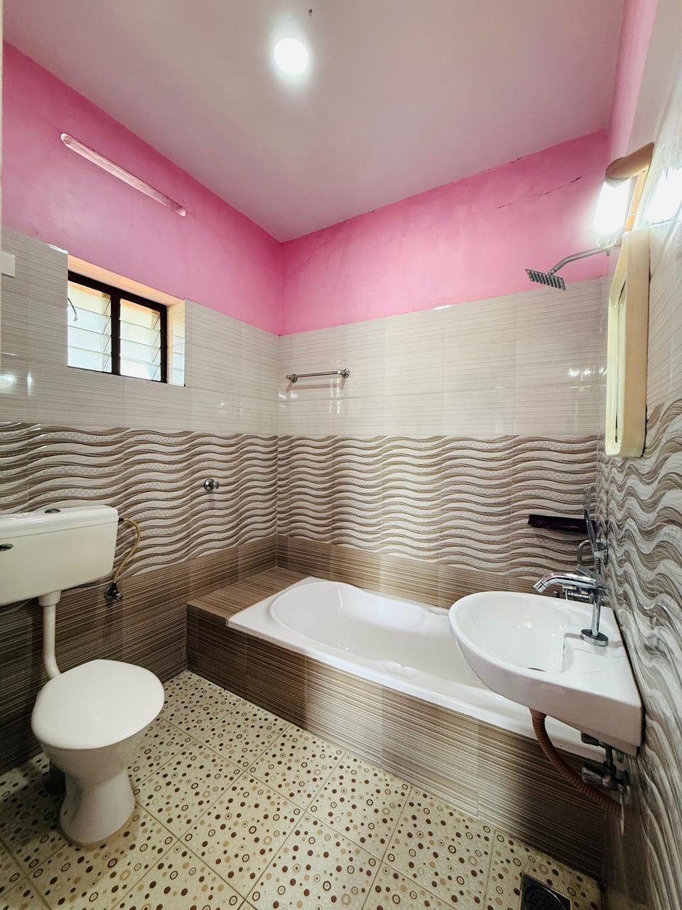 Private bathroom with bathtub, shower, toilet, and sink