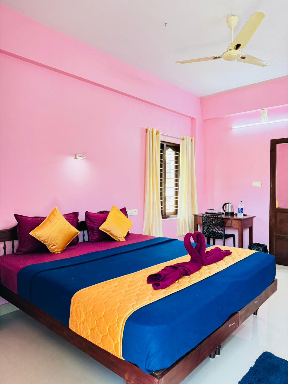 Double room arranged with towels and writing desk